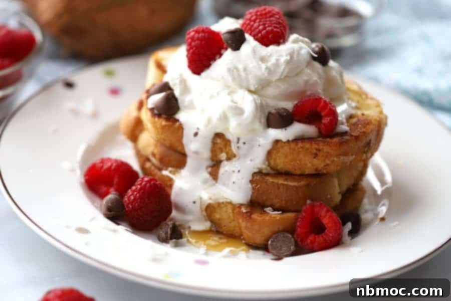 Double Coconut French Toast Delight 3 A stack of coconut french toast topped with coconut french toast syrup, whipped cream, chocolate chips, and fresh berries.