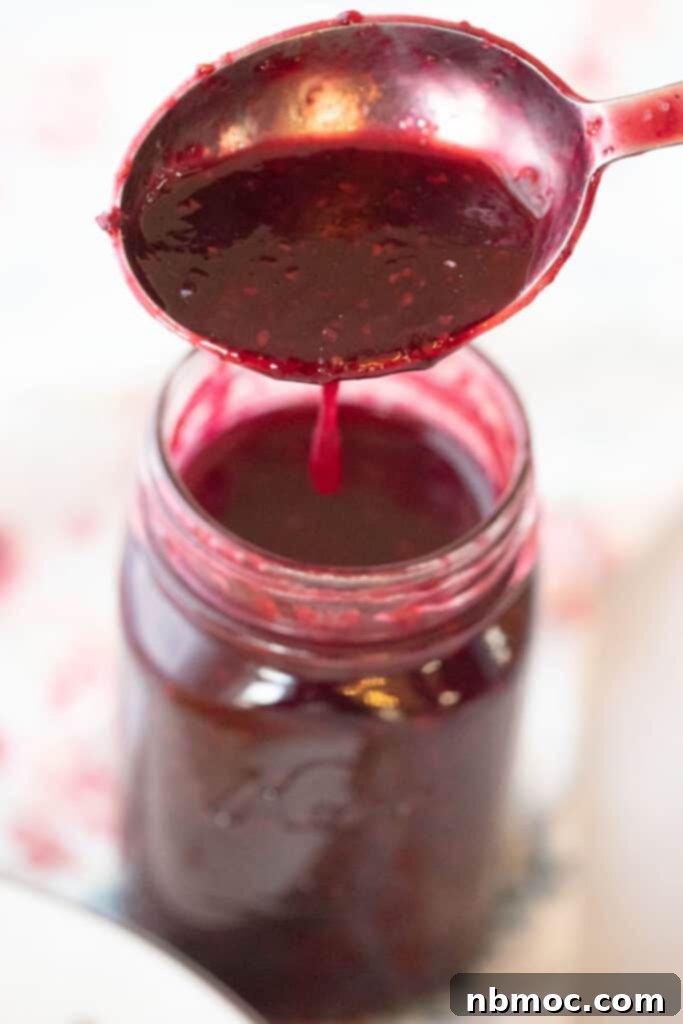 Homemade berry syrup recipe stored in a glass jar, ready for use.