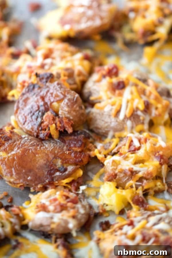 Cheesy smashed potatoes with bacon bits, an easy potato side dish recipe.