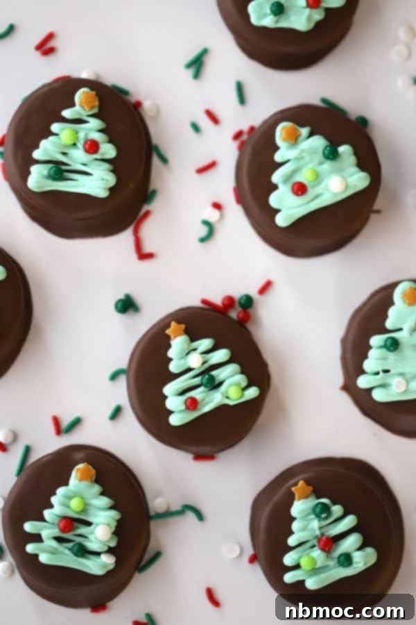 Festive Dipped Oreos adorned with delicate Christmas trees, showcasing easy homemade Christmas candy recipes.