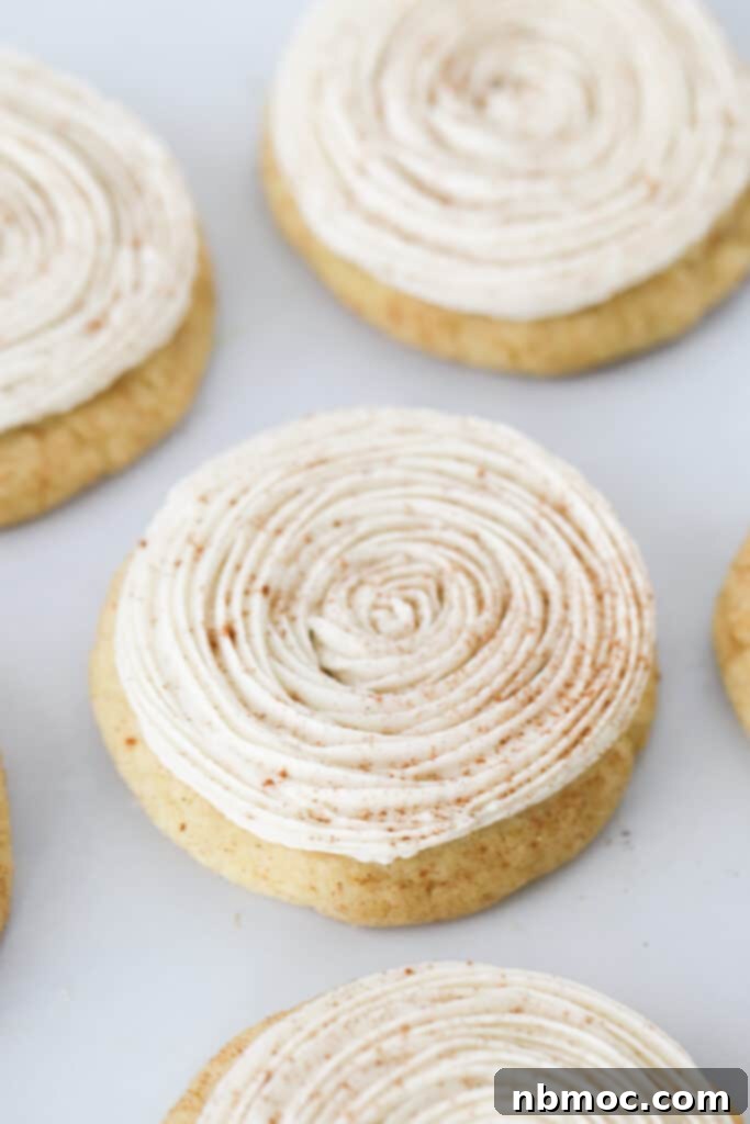 A close-up shot of soft pumpkin spice cookies, perhaps with a dusting of extra spice or a simple glaze, invitingly placed on a serving dish.