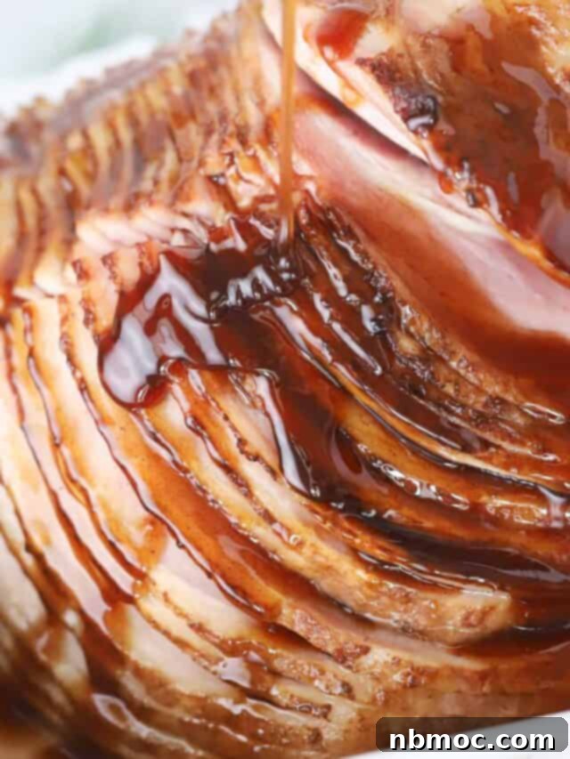 A spiral sliced ham with honey glaze for ham poured over the top.