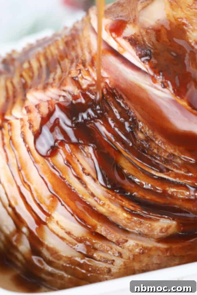 ham honey Glaze being drizzled over sliced honey baked ham.