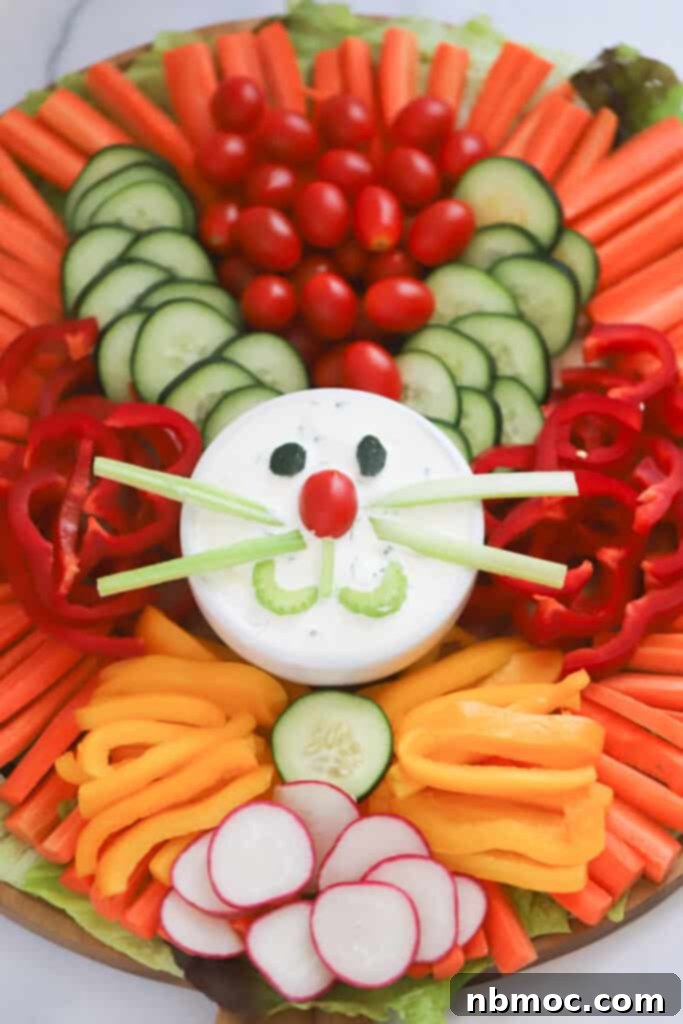Festive holiday veggie tray styled as an Easter bunny, featuring an assortment of colorful fresh vegetables and a homemade dip.