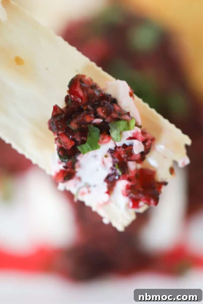A cracker with Cranberry Salsa and cream cheese.