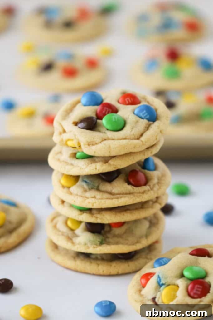 A vibrant stack of freshly baked M&M cookies, showcasing their colorful chocolate candy pieces.
