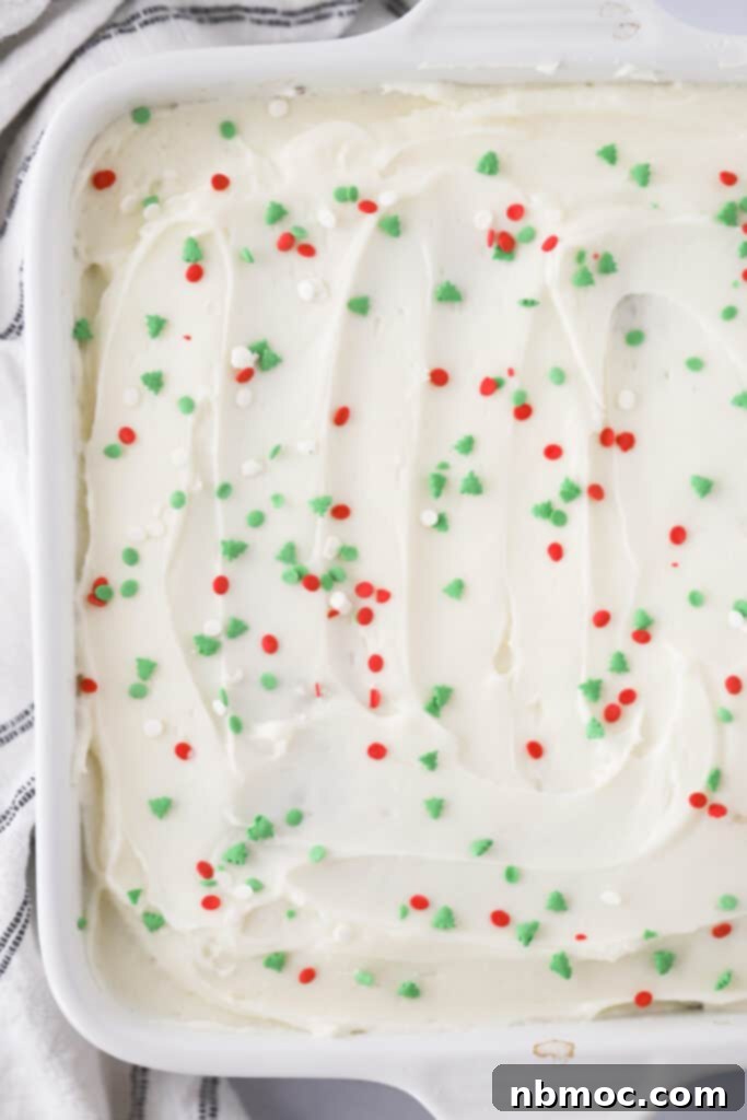 Aromatic Ginger Spice Bake 2 A beautifully frosted, old-fashioned gingerbread cake adorned with festive sprinkles, ready to be sliced and served at a holiday celebration.