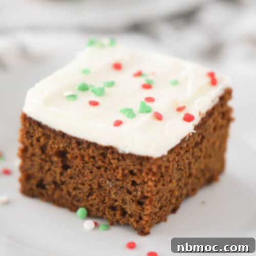 Aromatic Ginger Spice Bake 5 Close-up of a festive gingerbread cake slice showing its moist texture and rich buttercream frosting, ready to be enjoyed.