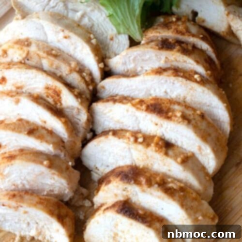 best baked chicken breast on a wood cutting board