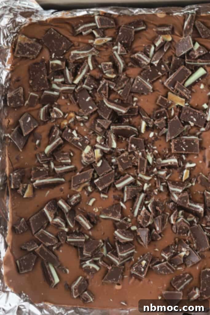 Andes mint chocolate fudge in a prepared baking dish, a favorite choc mint fudge recipe for the holidays.