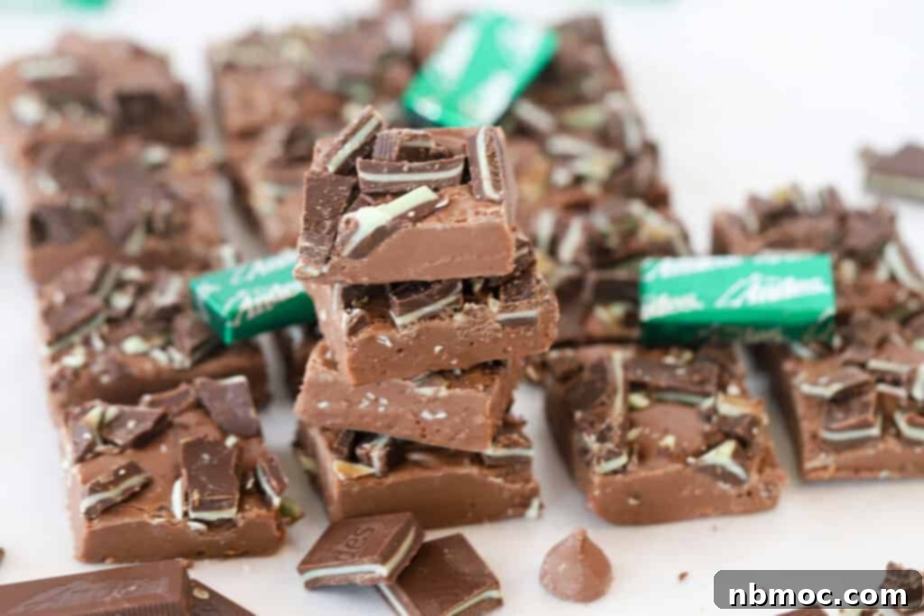 An easy recipe for mint chocolate fudge with squares of fudge stacked on each other.