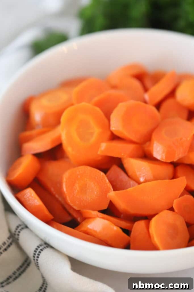 A bowl full of sliced honey and brown sugar glazed carrots, a delicious and easy side dish recipe.
