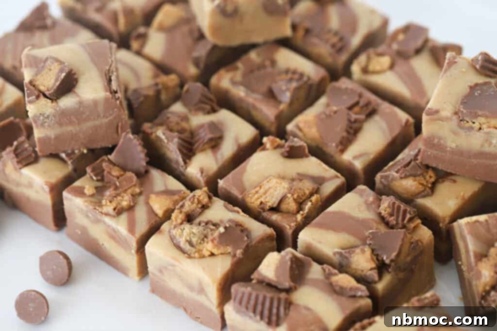 Reese's peanut butter fudge on a cutting surface, cut into bite sized pieces.
