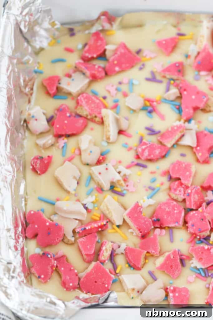 Whimsical Animal Cookie Fudge 2 Animal Cookie Fudge in a baking dish lined with foil.