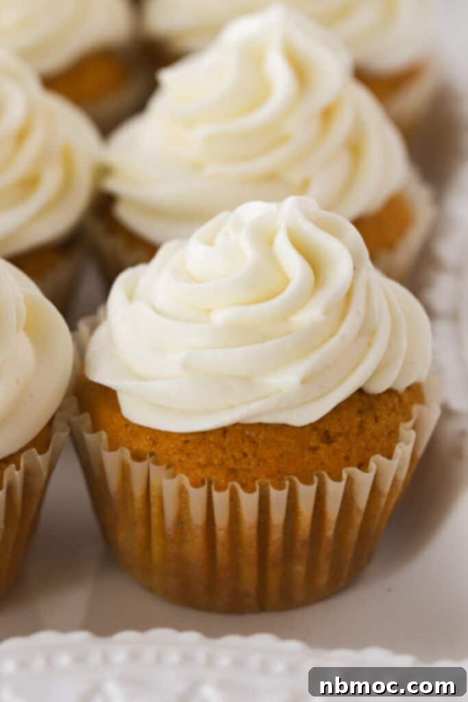 Whip Up Perfect Buttercream Frosting 3 Cupcakes generously topped with homemade buttercream icing, illustrating the perfect piping consistency and how to store buttercream frosting for later use.