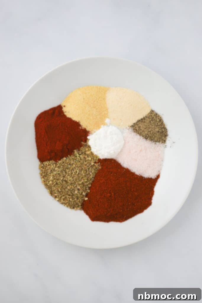 Different spices in a white bowl ready to make a spice mix. What is in taco seasoning? How to make homemade taco seasoning.