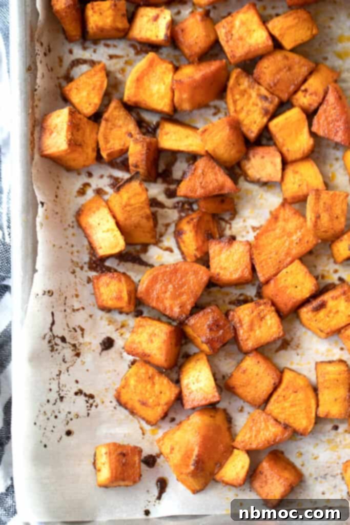 Smoky Chili Sweet Potato Cubes 4 Roasted sweet and spicy potatoes on a baking sheet.