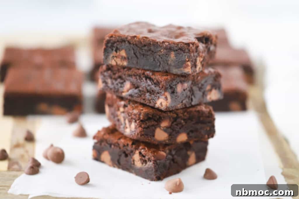 A stack of chewy fudge brownies with mini chocolate chips.