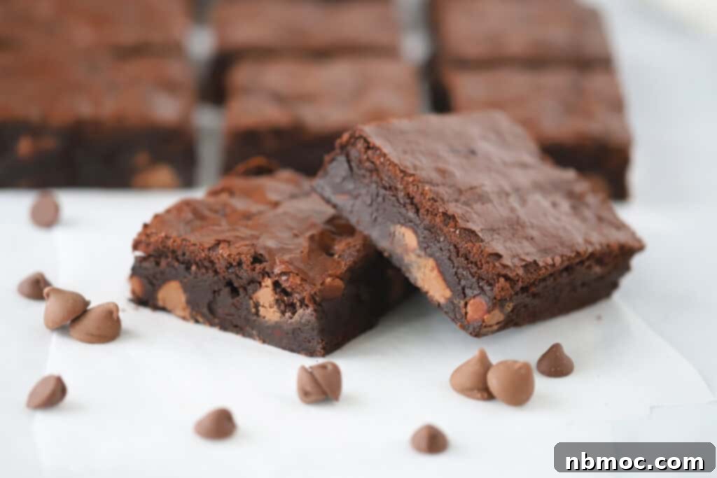Chewy Chocolate Brownies on a tabletop with chocolate chips.