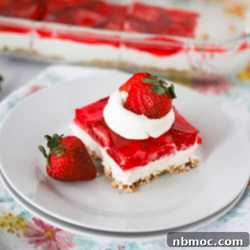 a square piece of strawberry salad recipe with whipped cream and a strawberry, recipe for strawberry pretzel salad..