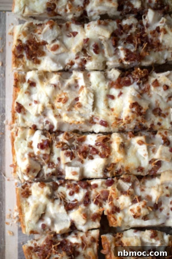 Effortless French Bread Pizza 2 Chicken and bacon French Bread Pizza, cooked and ready to be sliced.