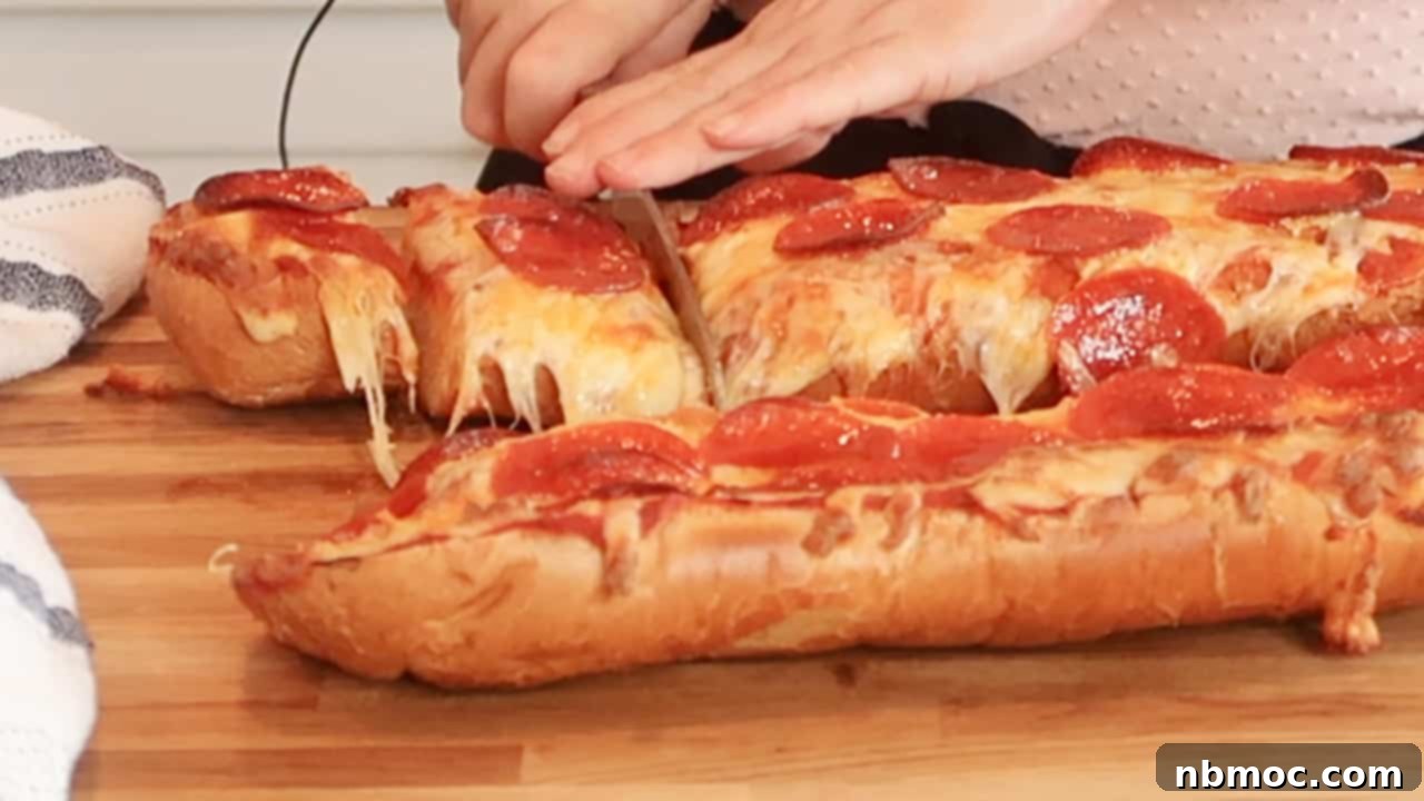 Effortless French Bread Pizza 6 Hands cutting loaves of cheesy pepperoni pizza bread into smaller slices.
