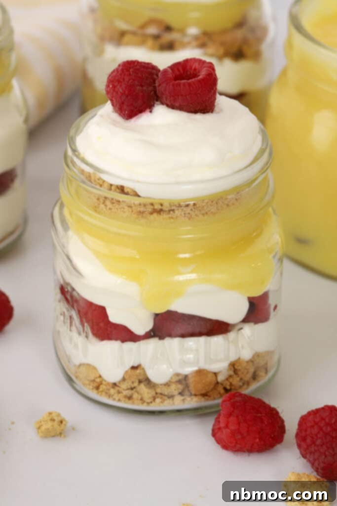 A beautiful lemon raspberry parfait, layered with cream, berries, and lemon curd, a perfect light dessert.