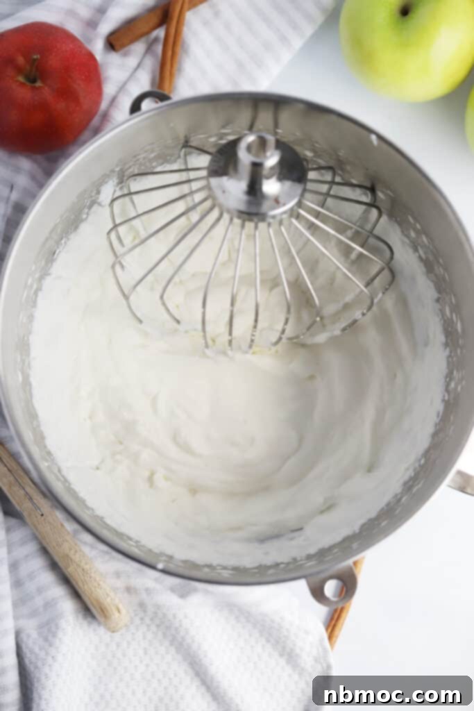 A bowl of freshly made homemade whipped cream, light and fluffy, perfect for topping desserts or breakfast.