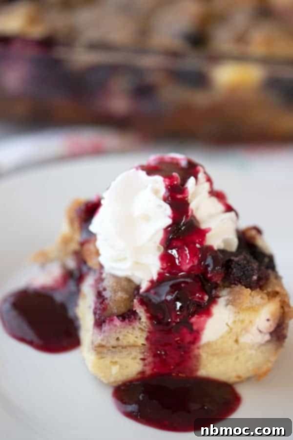 A mixed berry overnight French toast bake, rich with cream cheese and topped with streusel, an ideal make-ahead brunch dish.
