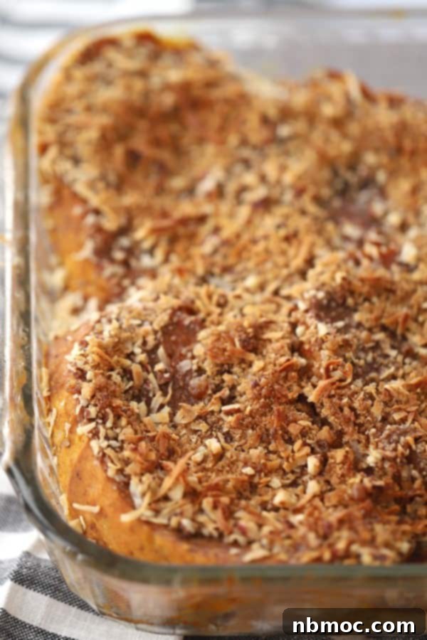 Cream cheese stuffed pumpkin French toast bake with a streusel topping, a comforting fall brunch dish.