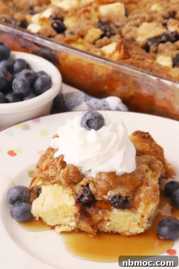 A blueberry breakfast casserole, generously topped with streusel, ideal for a holiday or weekend brunch.