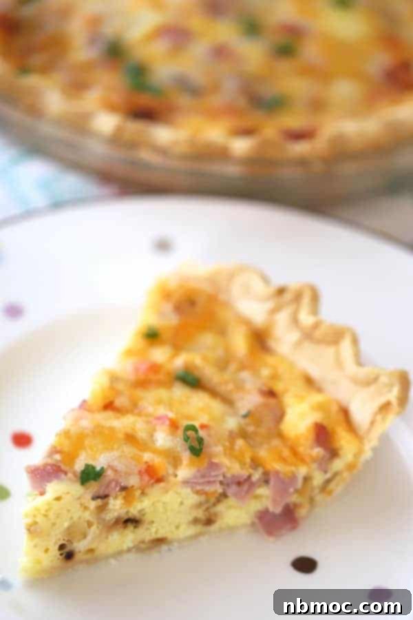 A golden ham and cheese quiche, boasting a flaky crust and savory filling, perfect for any brunch menu.