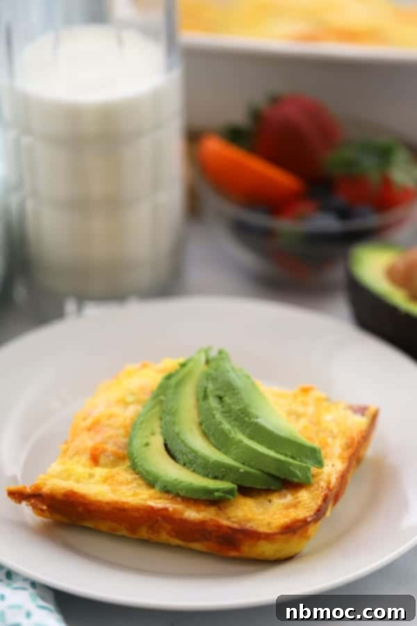 A robust sweet potato breakfast casserole, filled with ham, eggs, and cheese, an excellent choice for a brunch spread.