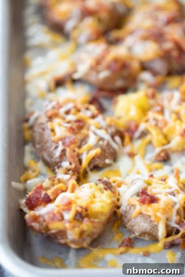 Smashed potatoes recipe baked in a dish, topped with cheese and bacon, an easy and fun potato recipe for brunch.