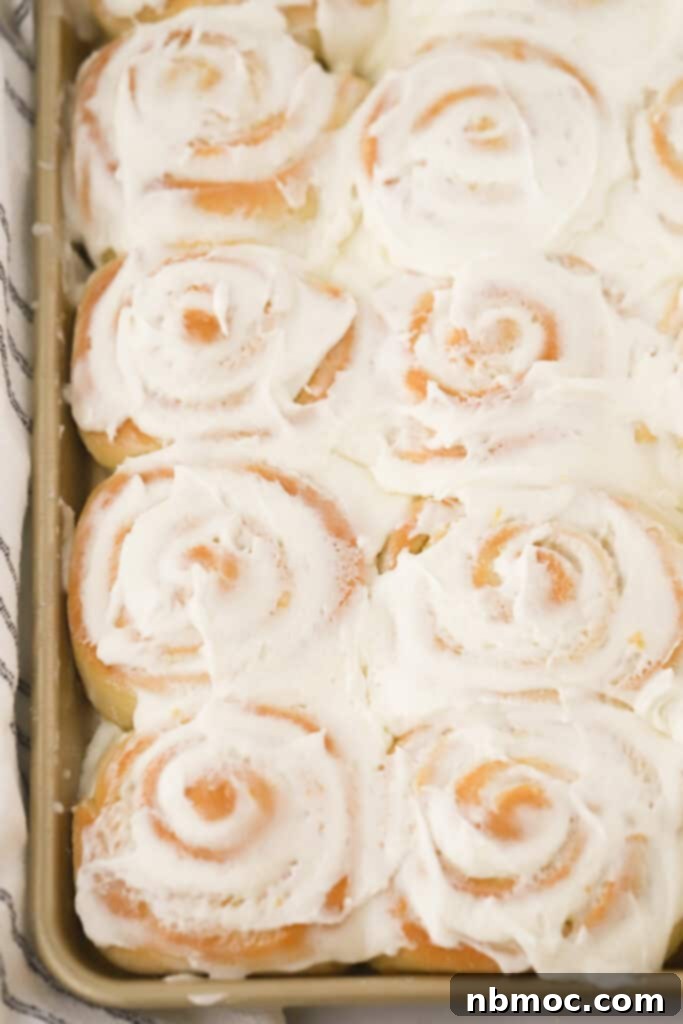 Swirls of lemon sweet rolls, glazed with lemon buttercream frosting, a delightful brunch or breakfast treat.