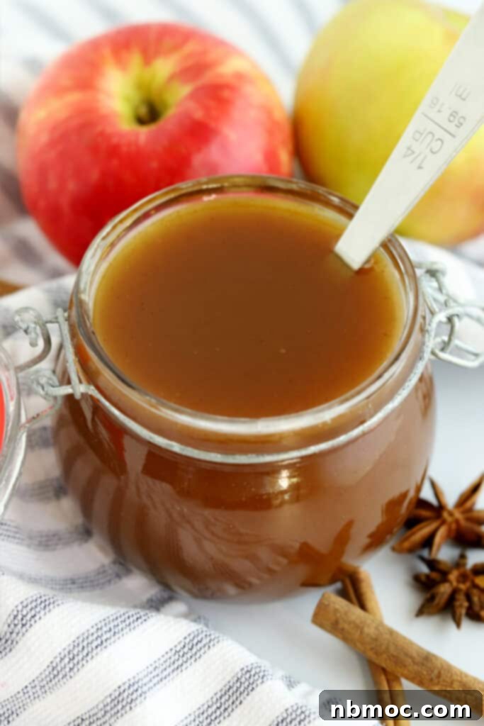 Apple cider syrup in a small pitcher, ready to be poured, a delicious seasonal brunch syrup.