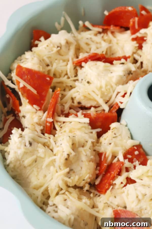 Pizza monkey bread, golden and cheesy, with pepperoni peeking through, a fun and savory recipe.