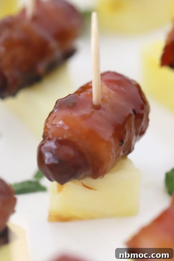 A plate of bacon wrapped smokies, glazed and ready to serve, a popular appetizer.
