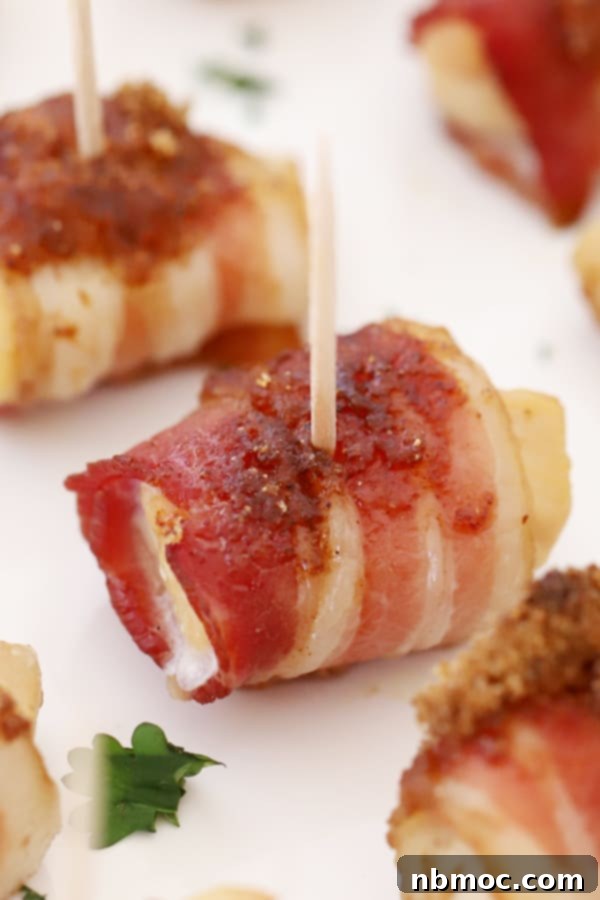 Bacon wrapped chicken bites, glazed and baked, a delicious and savory appetizer.