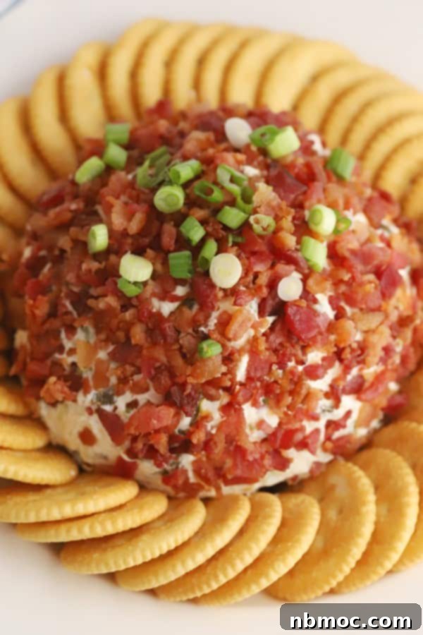 A savory jalapeno popper cheese ball, studded with bacon and served with crackers.