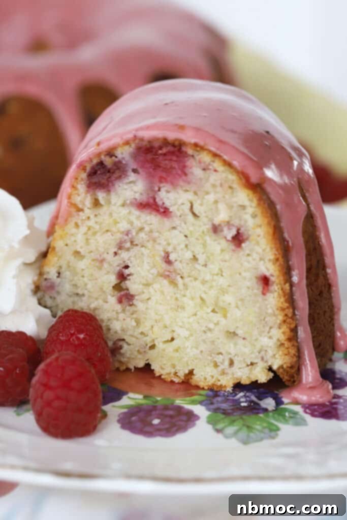 A beautiful raspberry lemon bundt cake, garnished with fresh raspberries, a delightful dessert.