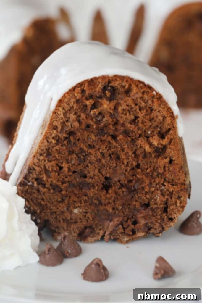 A rich chocolate bundt cake, drizzled with vanilla glaze, a simple yet elegant dessert.