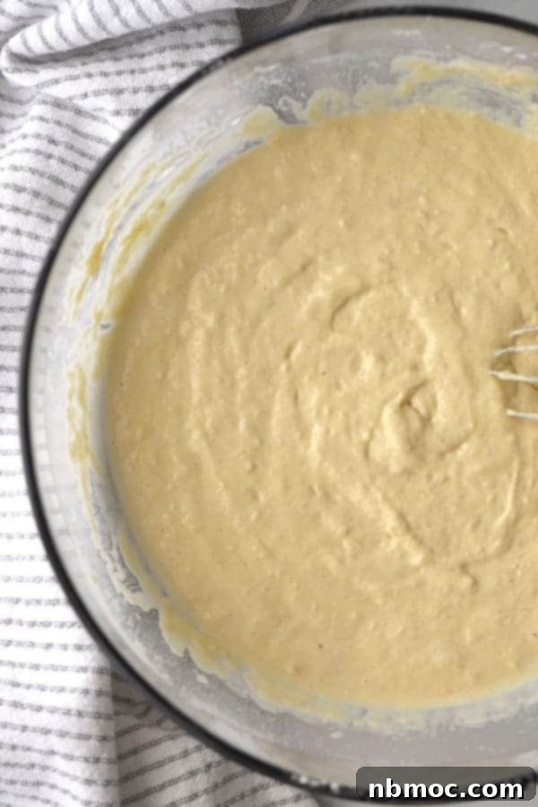einkorn buttermilk pancake batter in a clear bowl; sourdough discard pancakes.