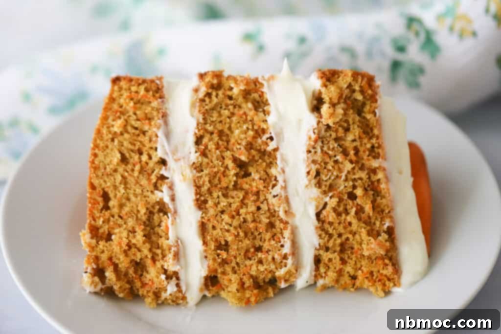 Ultimate Carrot Cake 6 A slice of our classic Carrot Cake recipe on a white plate.