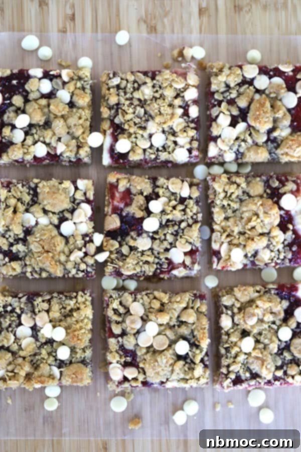 Beautifully arranged Raspberry White Chocolate Blondies, sliced into neat squares on a kitchen countertop, ready to be served and enjoyed.