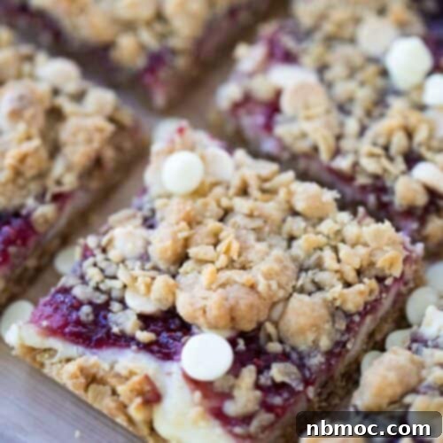 White Chocolate Raspberry Cheesecake Bars, a delightful dessert with an oatmeal cookie base, cheesecake, and raspberry swirl.