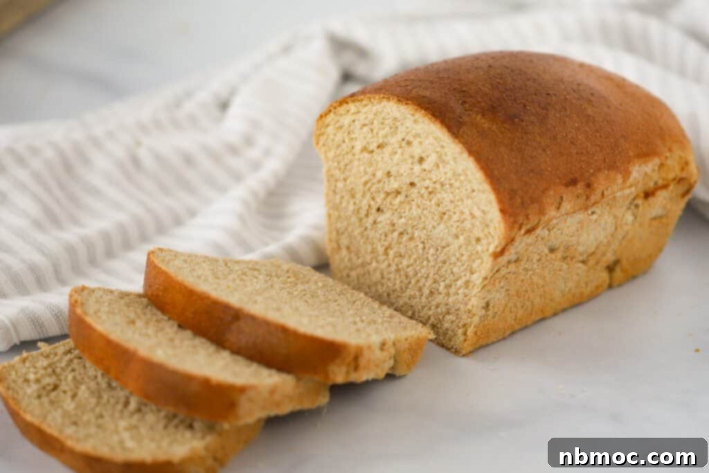 A rustic scene featuring a freshly baked loaf of soft whole wheat bread on a wooden table, with several perfectly cut slices ready to be enjoyed.