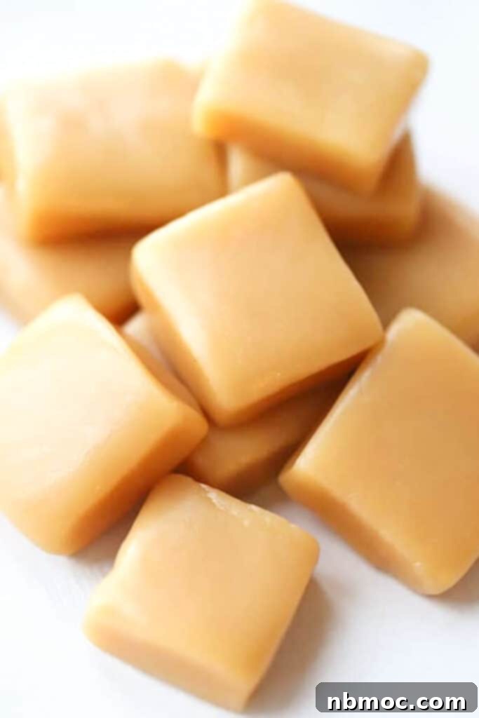 A pile of cut caramel squares on a table.