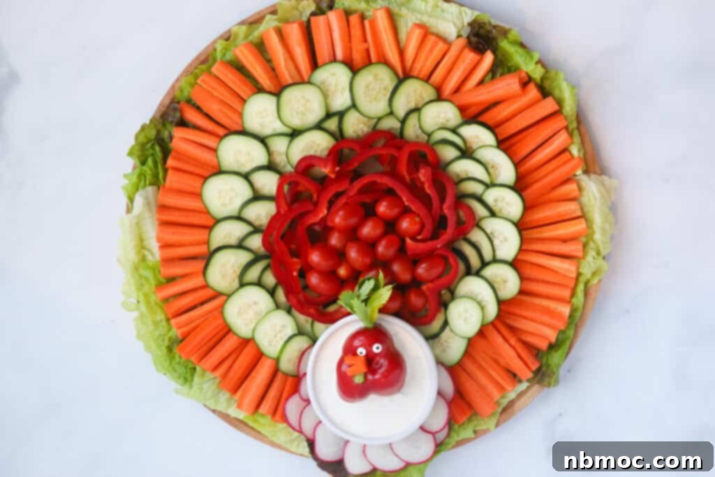 A vibrant 4th of July Veggie Tray with red peppers, cherry tomatoes, radishes, and blue potatoes, served with ranch dip.