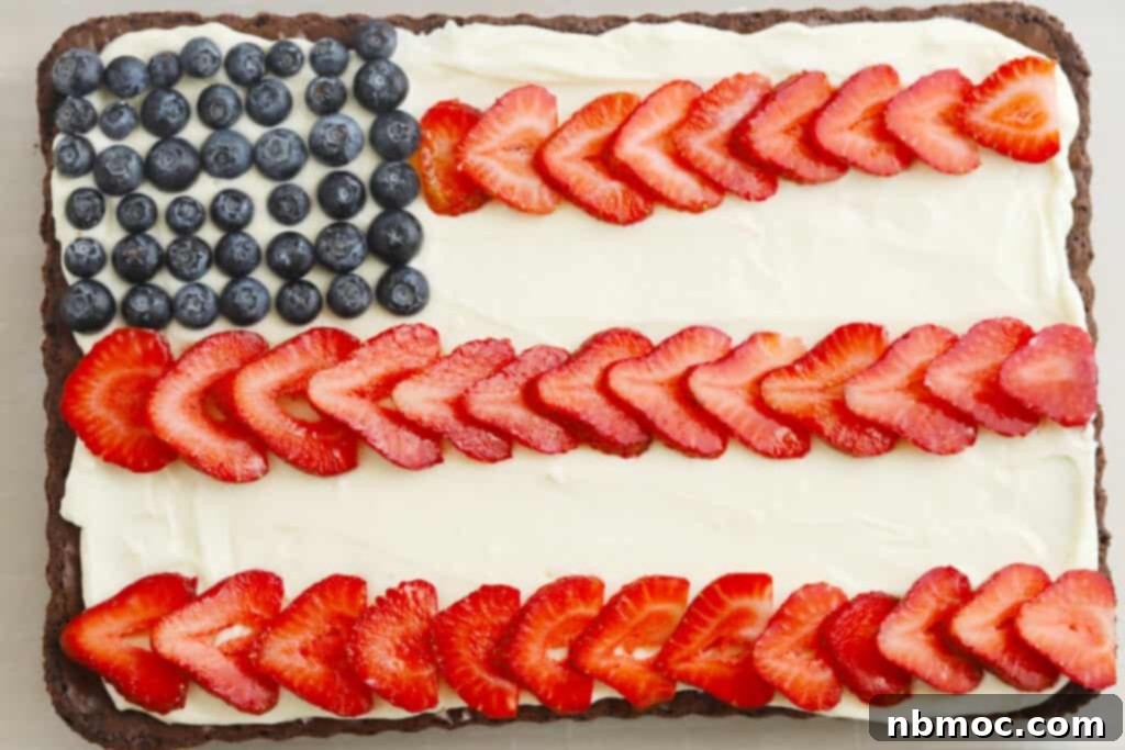 Delicious American Flag Brownies decorated with red, white, and blue frosting and berries, perfect for patriotic holidays.